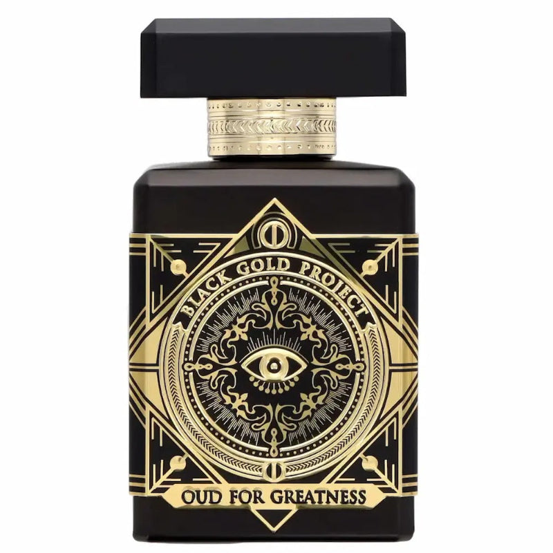 black initio oud for greatness bottle with gold accents and a black cap on a white background