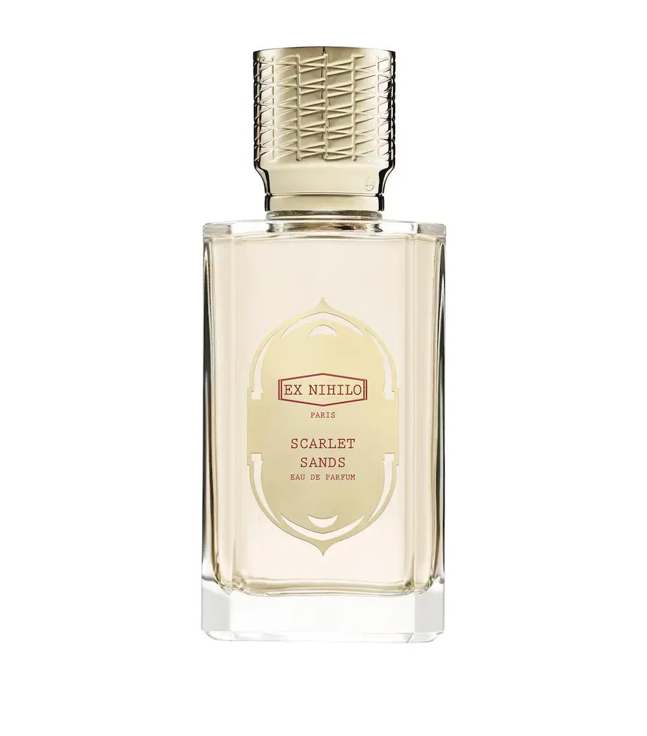 glass ex nihilo scarlet sands bottle with a gold cap on a white background 