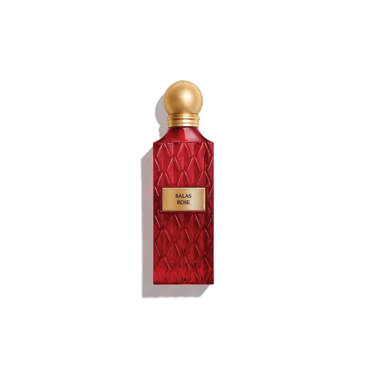 red perfume bottle with a gold cap and gold plate labelled 'balas rose' on a white background