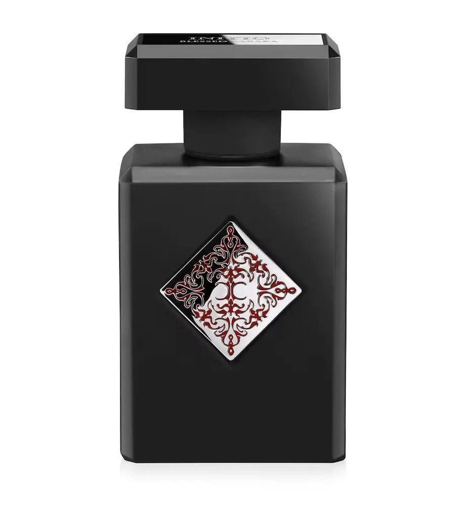 black initio blessed baraka perfume bottle with silver and red label and a black cap on a white background
