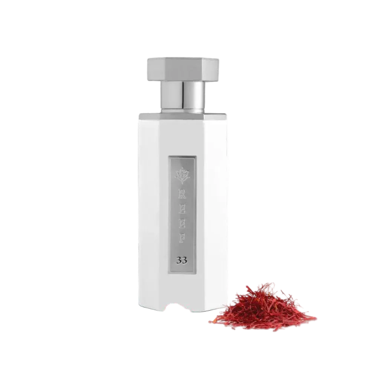 reef 33 white 100ml bottle in white with silver cap eau de parfum with saffron beside it